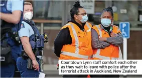  ??  ?? Countdown Lynn staff comfort each other as they wait to leave with police after the terrorist attack in Auckland, New Zealand