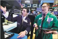  ?? Associated Press ?? Specialist Peter Mazza, left, and trader Ryan Falvey work on the floor of the New York Stock Exchange on Thursday.