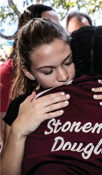  ?? Photo: Reuters ?? Marjory Stoneman Douglas High School pupils at a memorial after the shooting.