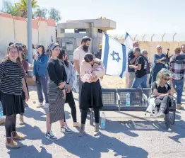  ?? AP ?? People gather at Israel’s Nitzana border crossing with Egypt in southern Israel yesterday, protesting against the delivery of humanitari­an aid to the Gaza Strip until all hostages held by Hamas militants are released.