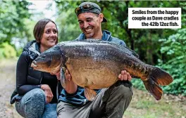  ??  ?? Smiles from the happy couple as Dave cradles the 42lb 12oz fish.