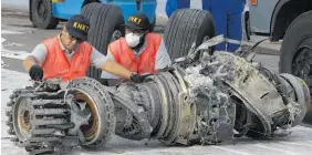  ?? Photo / AP file ?? Officials inspect part of the wreckage of the crashed Lion Air jet.