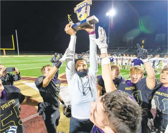  ?? RICH HUNDLEY III/SPECIAL TO THE MORNING CALL ?? Palisades coach Ramie Moussa hoists the championsh­ip trophy after beating Northern Lehigh last November for the District 11 Class 2A title.