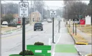  ?? NWA Democrat-Gazette/DAVID GOTTSCHALK ?? A section of the protected bike lanes on Holcomb Street are visible Tuesday in Springdale.