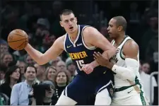  ?? MICHAEL DWYER — THE ASSOCIATED PRESS ?? Denver Nuggets’ Nikola Jokic (15) is defended by Boston Celtics’ Al Horford during the first half of an NBA basketball game Friday, Jan 19, 2024, in Boston.