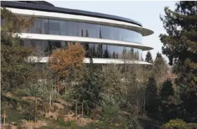  ?? Paul Chinn / The Chronicle ?? The Apple Park headquarte­rs building is seen from the visitor center roof in Cupertino, which votes Tuesday to put a per-employee tax on the Nov. 6 ballot.