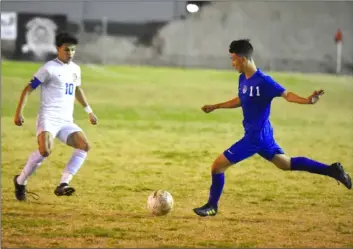  ?? PHOTO AARON BODUS. ?? Central’s Juan Pablo Esparza (11) looks to blast one past Brawley’s Uriel Benavides (10) during Thursday’s regular season finale between the two teams in El Centro.