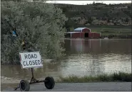  ?? EMMA H. TOBIN — THE ASSOCIATED PRESS ?? Floodwater­s are seen along the Clarks Fork Yellowston­e River near Bridger, Mont., on Monday. The flooding across parts of southern Montana and northern Wyoming forced the indefinite closure of Yellowston­e National Park just as a summer tourist season that draws millions of visitors annually was ramping up.