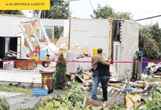  ?? FRED CHARTRAND / THE CANADIAN PRESS ?? A man and woman embrace as they survey damage to a home in Gatineau, Que., Sunday after two tornadoes swept through the area. Hundreds of families were forced to evacuate.