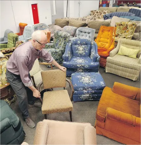  ?? JASON KRYK ?? Bob Cameron, director of the Downtown Windsor Community Collaborat­ive, sorts through furniture at the Windsor Furniture Bank on Marion Avenue on Monday. The furniture bank is set to close next month after the city-owned building it operated in for free...