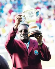  ?? FILE ?? Clive Lloyd, captain of the West Indies’ two World Cup winning sides, holds aloft one of the trophies during a ceremony honouring the players of the 1975 and 1979 sides at Sabina Park in 2007.