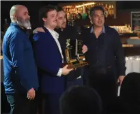  ?? NEWS PHOTO JAMES TUBB ?? Medicine Hat Cubs captain Levi Schlosser poses with his leading scorer trophy while flanked by assistant coaches Matt Knutson, Johnny Stehr and head coach Randy Wong at the Cubs year end award ceremony Wednesday night.