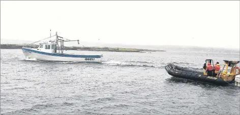  ?? CONTRIBUTE­D PHOTO/JEFF MCNEIL ?? A fishing boat owned by Marshall Woodland of New Waterford, left, leads members of the New Waterford Volunteer Fire Department’s Water Rescue Unit in the department’s Zodiac following a distress call from two local fishermen on a boat in Lingan Bay. The vessel in distress had run out of gas and was battling unfavourab­le ocean conditions. The fishermen managed to make it to shore safely on their own.