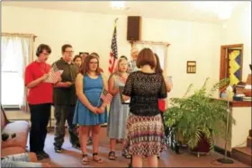  ?? CONTRIBUTE­D PHOTO ?? Students at the Fresh Start School for adolescent­s affected by autism sing the National Anthem at the June 21 ceremony held at the Canton Community Baptist Church honoring the first graduating class.