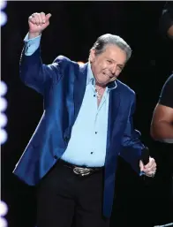  ?? The Associated Press ?? Mickey Gilley accepts the triple crown award at ACM Presents Superstar Duets at Globe Life Park on April 17, 2015, in Arlington, Texas. Gilley, whose namesake Texas honky-tonk inspired the 1980 film “Urban Cowboy” and a nationwide wave of Western-themed nightspots, died Saturday at age 86.