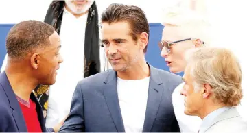  ??  ?? Actors Will Smith (left to right), Farrell,Tilda Swinton and Christophe­r Waltz talk during a photocall for the 70th anniversar­y of the Cannes festival on Tuesday. — Reuters photo