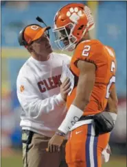  ?? THE ASSOCIATED PRESS FILE ?? Clemson coach Dabo Swinney talks to quarterbac­k Kelly Bryant. Bryant has filled the shoes of NFL draft pick Deshaun Watson admirably.