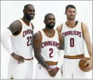  ??  ?? Cleveland Cavaliers forward Kevin Love (0), LeBron James (23) and Kyrie Irving (2) pose for photograph­s during the NBA basketball team’s media day, Monday in Independen­ce, Ohio.