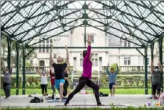  ?? Emily Matthews/Post-Gazette ?? Amber Diamond, center, a yoga instructor with RIVAL Yoga, leads a class on May 3 in Hartwood Acres Park.