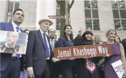  ?? GEMUNU AMARASINGH­E/AP ?? Participan­ts stand for a photo after unveiling a new street sign for Jamal Khashoggi Way outside of the Embassy of Saudi Arabia last Wednesday in Washington.