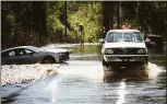  ?? ?? Regina Matthews rides in the back of a truck across a flooded Elliott Bridge Road in Linden, N.C., in 2018.