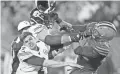 ?? AP ?? Browns defensive end Myles Garrett (95) hits Steelers quarterbac­k Mason Rudolph (2) with a helmet Thursday.