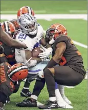  ?? Ronald Martinez / Getty ?? Dallas’ Ezekiel Elliott is tackled by the Cleveland defense late in the Browns’ 49-38 win on Sunday in Texas.