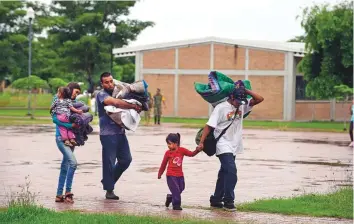  ?? AFP ?? People arrive at an improvised shelter in Escuinapa. More than 4,250 people were evacuated from high-risk areas, including tourists who were on vacation, authoritie­s said.