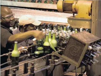  ??  ?? SAB employees work on the beer production line. SABMiller’s chairman, Jan du Plessis, expressed regret of looming job losses as a result of the merger.