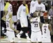  ?? TONY DEJAK — THE ASSOCIATED PRESS ?? Cavaliers forward LeBron James (23) and teammate Kyrie Irving celebrate during the first half against the Warriors in Game 4 of the NBA Finals on Friday.