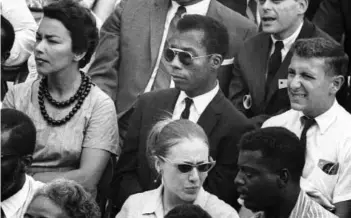  ?? DAN BUDNIK/MAGNOLIA PICTURES ?? James Baldwin, centre, is seen in a still from I Am Not Your Negro, Raoul Peck’s Oscar-nominated documentar­y in which Baldwin’s searing observatio­ns on race and America are resurrecte­d. Peck and others say Baldwin’s words could hardly be more urgent...