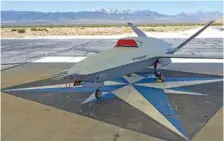  ?? AP PHOTO/DAMIAN DOVARGANES ?? The XQ-67A Off-Board Sensing Station unmanned aerial vehicle, one prototype of the future AI drone fleet developed under the USAF’s Air Force Research Laboratory, is displayed May 1 at General Atomics’ test facility at Gray Butte in Palmdale, Calif.