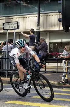  ??  ?? Above: The Hammer Sprint, a city crit race in the shadow of Hong Kong island, sees a peloton of big-name riders fragmented over 40km of back-to-back points sprintsRig­ht: Leonardo Basso of Team Sky leads the peloton into one of the tight and technical corners