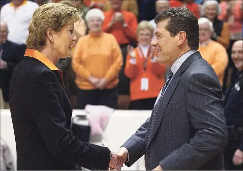  ?? Associated Press file photo ?? Tennessee coach Pat Summitt, left, shakes hands with UConn coach Geno Auriemma before a 2006 game in Knoxville, Tenn.