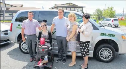  ?? SADIE-RAE WERNER/SPECIAL TO THE TELEGRAM ?? (From left) Lewisporte-twillingat­e MHA Derek Bennett, Evan Bursey, Karen Davis, Lisa Dempster, Minister Responsibl­e for the Status of Persons with Disabiliti­es, and Harbour Main MHA Betty Parsley, are shown in front of Bursey’s Taxi, inc.’s accessible...