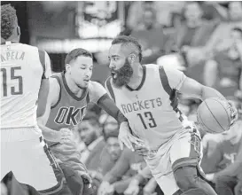  ?? Michael Wyke / Associated Press ?? Rockets guard James Harden (13) takes a Sunday drive toward the basket, thanks to a second-half pick set by teammate Clint Capela on the Oklahoma City Thunder’s Andre Roberson.