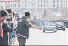  ?? ?? Spectators watch modified cars compete in a drag race along a street during a car racing competitio­n in Kabul.