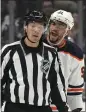  ?? ?? Edmonton left wing Evander Kane, right, yells at linesman Bryan Pancich during the first period in Game 4 on Sunday in Los Angeles.