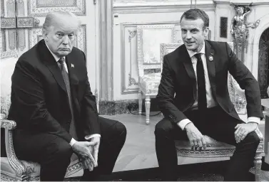 ?? SAUL LOEB / AFP/Getty Images ?? President Donald Trump and French President Emmanuel Macron met Saturday in Paris. But on Tuesday, Trump’s tweets included a fresh complaint about Macron’s suggestion that Europe build up its militaries.