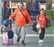  ?? CAITIE MCMEKIN/KNOXVILLE NEWS SENTINEL VIA AP ?? On Feb. 9, Yassin Terou, left, and Noor Ibrahim walk toward the security checkpoint for a flight to Syria from McGhee Tyson Airport in Knoxville.