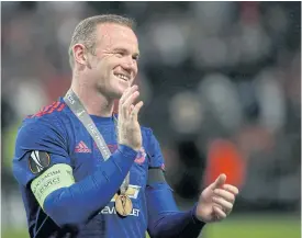  ??  ?? United’s Wayne Rooney celebrates his team’s victory in the Europa League final.