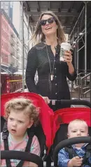  ?? HILARY SWIFT / THE NEW YORK TIMES ?? Savannah Guthrie, co-anchor of NBC’S “Today” show, takes a stroll with her children, Vale and Charley Feldman, in Manhattan.