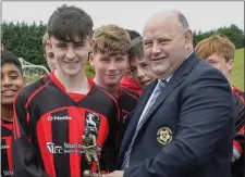  ??  ?? Player of the match Ryan Connolly (Gorey Rangers) receives his trophy from Don Hearne after their Under-15 Cup final win over North End.