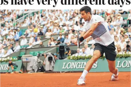  ?? THE ASSOCIATED PRESS ?? Novak Djokovic plays a shot against Diego Schwartzma­n in their third-round match at the French Open. Friday proved a challengin­g day for Djokovic, who had 55 unforced errors but managed to overtake Schwartzma­n after he started experienci­ng hip trouble.