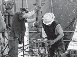  ?? Brittany Sowacke / Bloomberg file ?? Workers connect drill bits and drill collars on a rig near Midland. CLEAR at the University of Texas at Arlington found that most companies work carefully to minimize the environmen­tal impact.