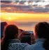  ?? ?? RUGGED AND BEAUTIFUL: from top, North Cape on the island of Mageroya, in the far north of Norway; getting a scenic sunset photo on the island of Senja, in Troms og Finnmark county; the MS-Kong Harald, Raftsundet, dwarfed by the majesty of the fjords