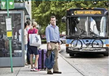  ?? Miami Herald File ?? Miami-Dade County adjusted bus service and capacity as ridership decreased during the coronaviru­s pandemic. In busier times, Randy Plant, who commutes from South Beach to Coral Gables each day, waited for a Metrobus.