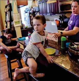  ?? Washington Post photo by Bill O’Leary ?? The Senff kids, Avery, left, and Colby, are both going to school online. Their parents are working from home.