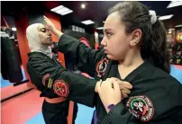  ?? AFP ?? Asma Hasnawi, a Kajukenbo hybrid martial art assistant-master, practises with her daughter Riham, in a club in Kuwait City. —