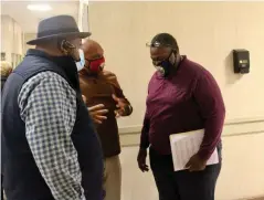  ?? (Pine Bluff Commercial/Eplunus Colvin) ?? After the Quorum Court meeting in January, County Judge Gerald Robinson (center) speaks with Tax Collector Tony Washington (right) while Justice of the Peace Reginald Adams listens in.